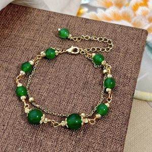 Double-layered green chalcedony beaded bracelet with gold plated accents and flowers