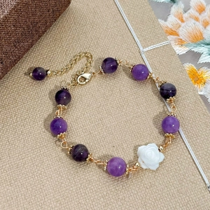Handmade gold plated bracelet with purple natural stones and a white rose shell flower