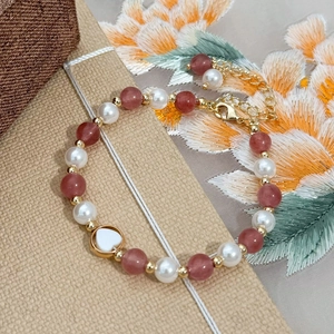 Handmade pearl and pink crystal bead bracelet with gold heart pendant and lobster clasp