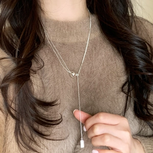 Elegante verstellbare silberne Y-Halskette mit Gleitverschluss auf braunem Pulli