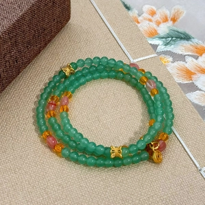 Three-layer green natural stone beaded bracelet with gold coin charm and butterfly accents