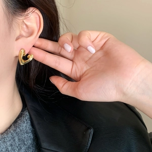 Minimalist gold heart-shaped metal stud earrings for women with a sleek mirror finish