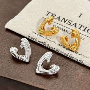 French vintage hollow heart earrings in gold and silver with wavy metal texture