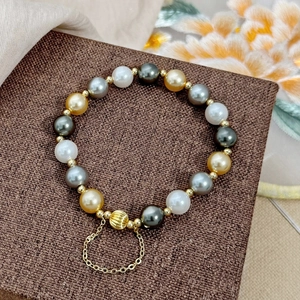 Multicolor pearl bracelet with gold plated pumpkin beads and delicate safety chain