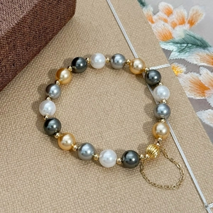 Elegant multi-color pearl bracelet with golden pumpkin charm and adjustable tail chain