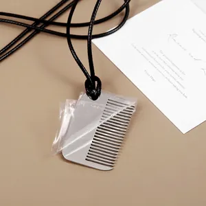 Waterproof black cord necklace with silver comb pendant and protective film removal