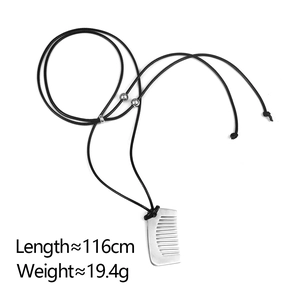 Detail of silver comb pendant necklace with adjustable black wax cord and three beads