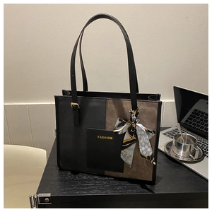 Detail of large tote bag with silk scarf, mixed leather textures and FASHION logo