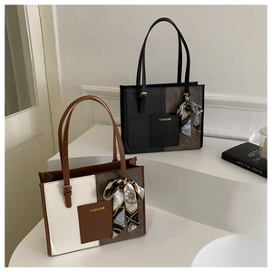 Detail of contrast color tote bag with decorative fashion pocket and stylish silk scarf