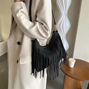 French style black tassel bucket bag with matte finish and long fringe details