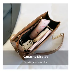 Capacity display of the brown quilted leather bag showing interior storage and gold chain