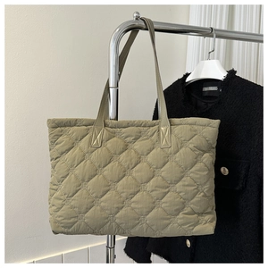 Detailed view of olive green quilted cotton tote bag with diamond stitching and soft handles