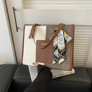 Minimalist color-block tote bag in cream and brown with chic scarf-wrapped handle