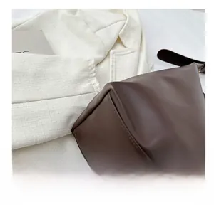 Close-up of precise stitching and high-quality leather texture on a brown tote bag