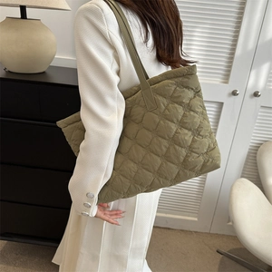 Olive green quilted tote bag with diamond stitching and shoulder strap for casual style