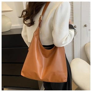 Brown large-capacity PU leather tote bag shown on model for realistic size and drape