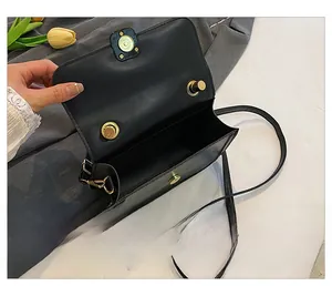 Interior view of the black leather crossbody bag showing magnetic closure and storage space