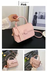 Detailed view of pink PU leather crossbody bag with rounded handle and fashion pendant