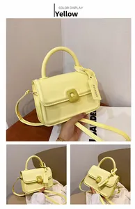 Detail of yellow matte leather mini bag with square clasp and fashion brand tag