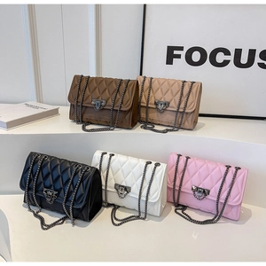 Detail display of five quilted chain crossbody bags in various colors on steps