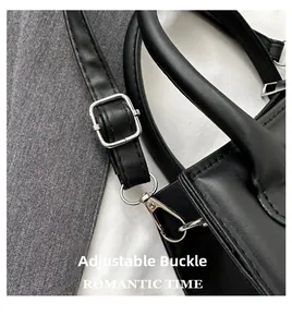 Detail of adjustable shoulder strap with silver metal buckle on a black leather handbag
