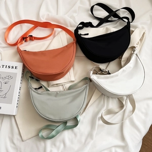 Minimalist nylon crescent crossbody bags in four colors with adjustable wide straps