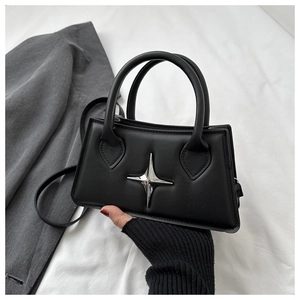 Detail of black matte leather mini square bag with silver star metal decoration