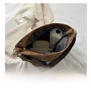 Detail view of large capacity tote bag interior with vintage strap and daily essentials