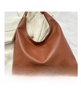 Detailed view of brown lychee grain PU leather tote bag with elegant gold metal zipper