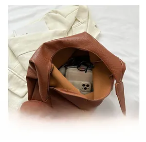 Top view of large brown tote bag showing spacious interior with zipper closure