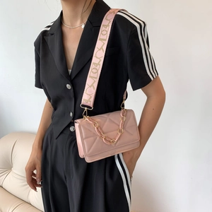 Pink quilted crossbody bag with stylish wide patterned strap and acrylic chain detail