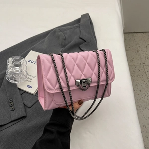 Pink quilted crossbody bag with diamond stitch and metal chain strap in urban style