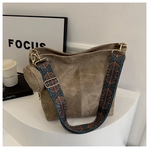 Gros plan du sac cabas en daim terreux avec une bandoulière large aux motifs bohémiens