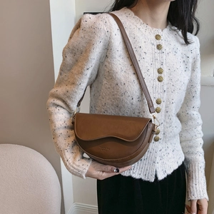 Classic brown matte saddle bag with adjustable leather strap and golden hardware buckle
