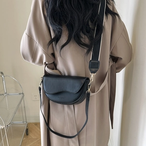 Classic black saddle bag with wavy flap design and dual stylish shoulder straps