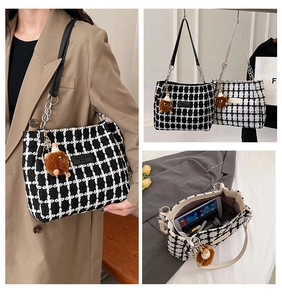 Detail of checkered tweed tote bag showing large capacity for tablets and teddy bear charm