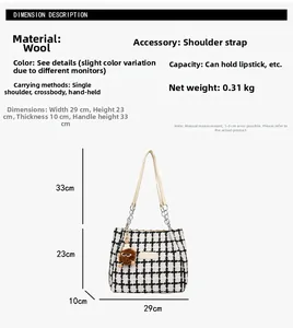 Detail view of black and white plaid tote bag with chain strap and brown plush charm