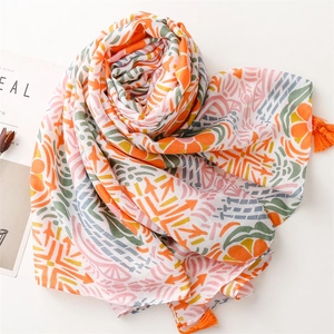 Abstract geometric floral cotton linen scarf with orange tassels on a minimal background