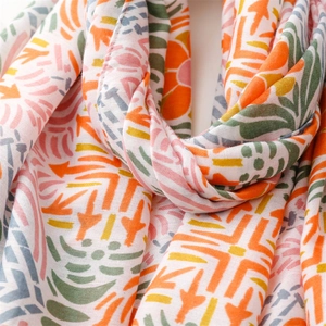 Close-up of lightweight cotton linen scarf with vibrant colorful geometric floral patterns