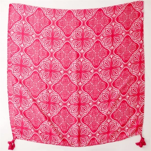 Detail of rose pink geometric flower pattern on cotton linen scarf with tassel charms