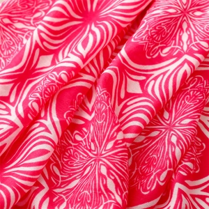 Macro detail of rose pink cotton linen shawl featuring symmetrical floral mandala patterns