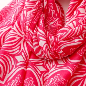 Close-up of red and white floral cotton linen scarf featuring soft tassels and ethnic prints