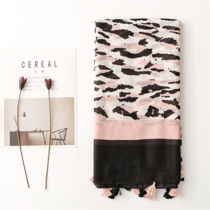 Pink and black leopard print cotton linen scarf with tassel fringe on white background