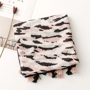 Detailed view of artistic pink and black tiger print scarf with delicate tassels