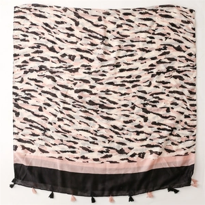 Detail of cotton linen leopard print scarf featuring stylish black and pink tassels fringe