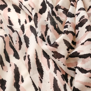 Macro detail of zebra print cotton linen scarf fabric showing texture and soft draping