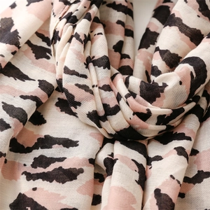 Detail of soft leopard print cotton linen scarf with elegant fringe and pink accents