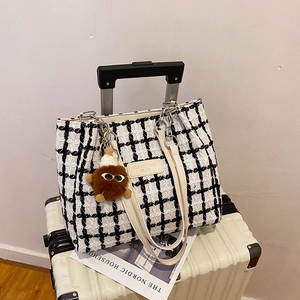 Classic black and white checkered tweed tote bag with leather straps and bear charm
