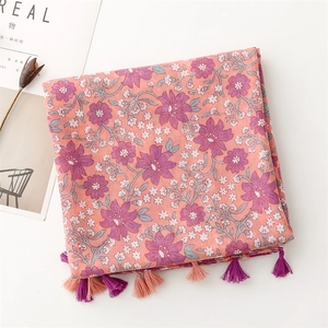Close-up of pink floral print cotton scarf featuring decorative dual-color fringe tassels