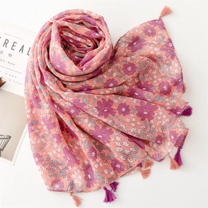 Detail of floral pink beach shawl with soft tassels and delicate flower pattern print